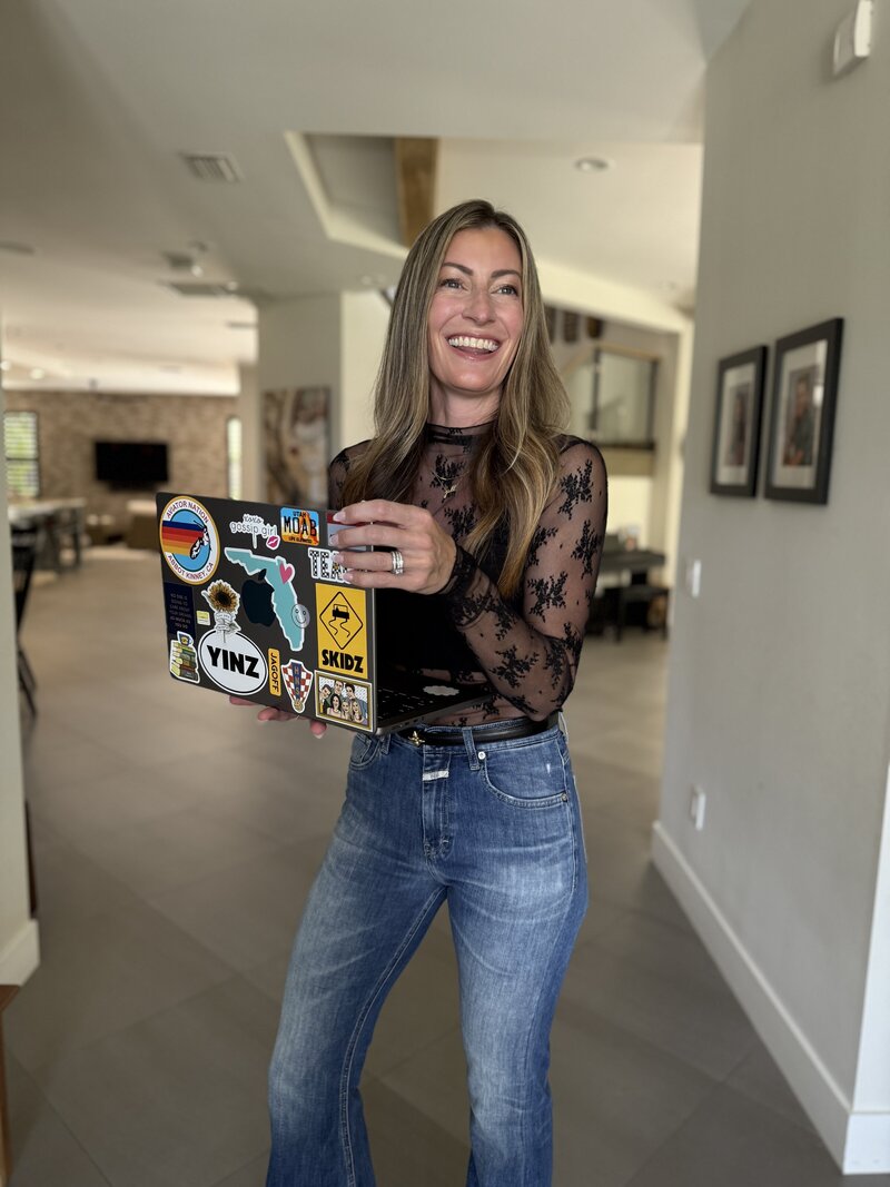 Jill smiling in a black shirt and blue jeans