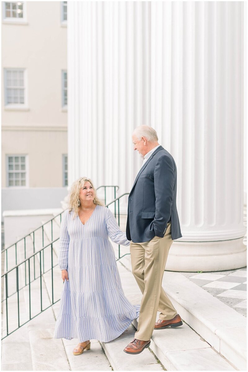 couple walking down steps in Charleston, SC