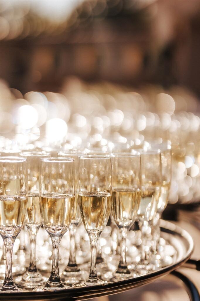 Champagne glasses on a tray | CM Promotions corporate event planning in Dallas and Fort Worth