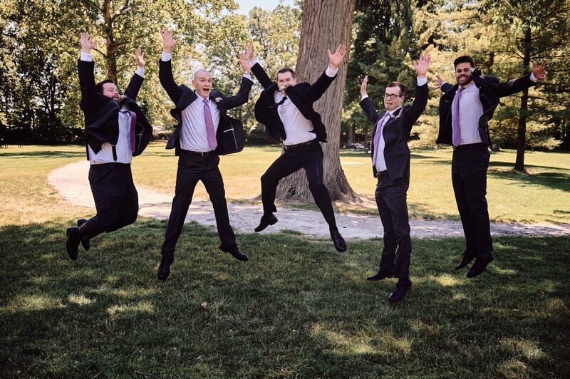 Groom and Groomsmen Jump in the air at Dodge Park in Sterling Heights, Michigan