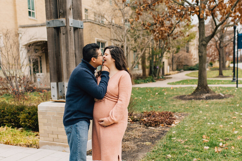Man kisses pregnant wife at the Xavier University campus