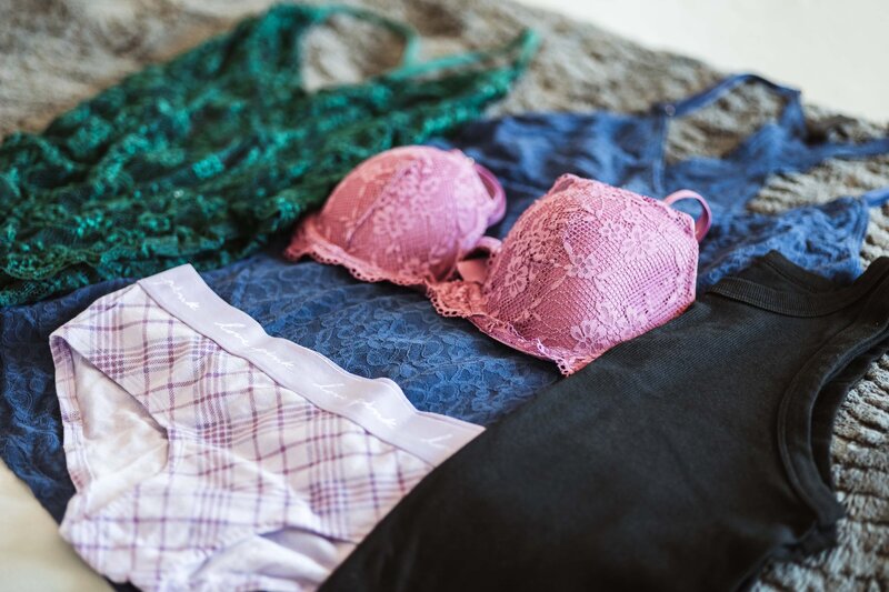 Colorado Springs Boudoir Photographer lingerie wardrobe on bed