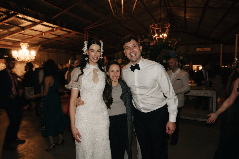 sarah godenzi standing with one of her couples at their cadella park wedding