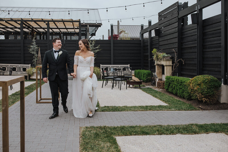A wedding couple holding hands and walking together