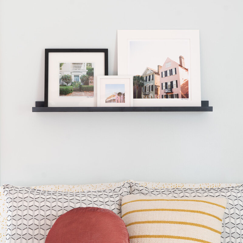 Three Charleston SC photography prints displayed on a  photo ledge shelf