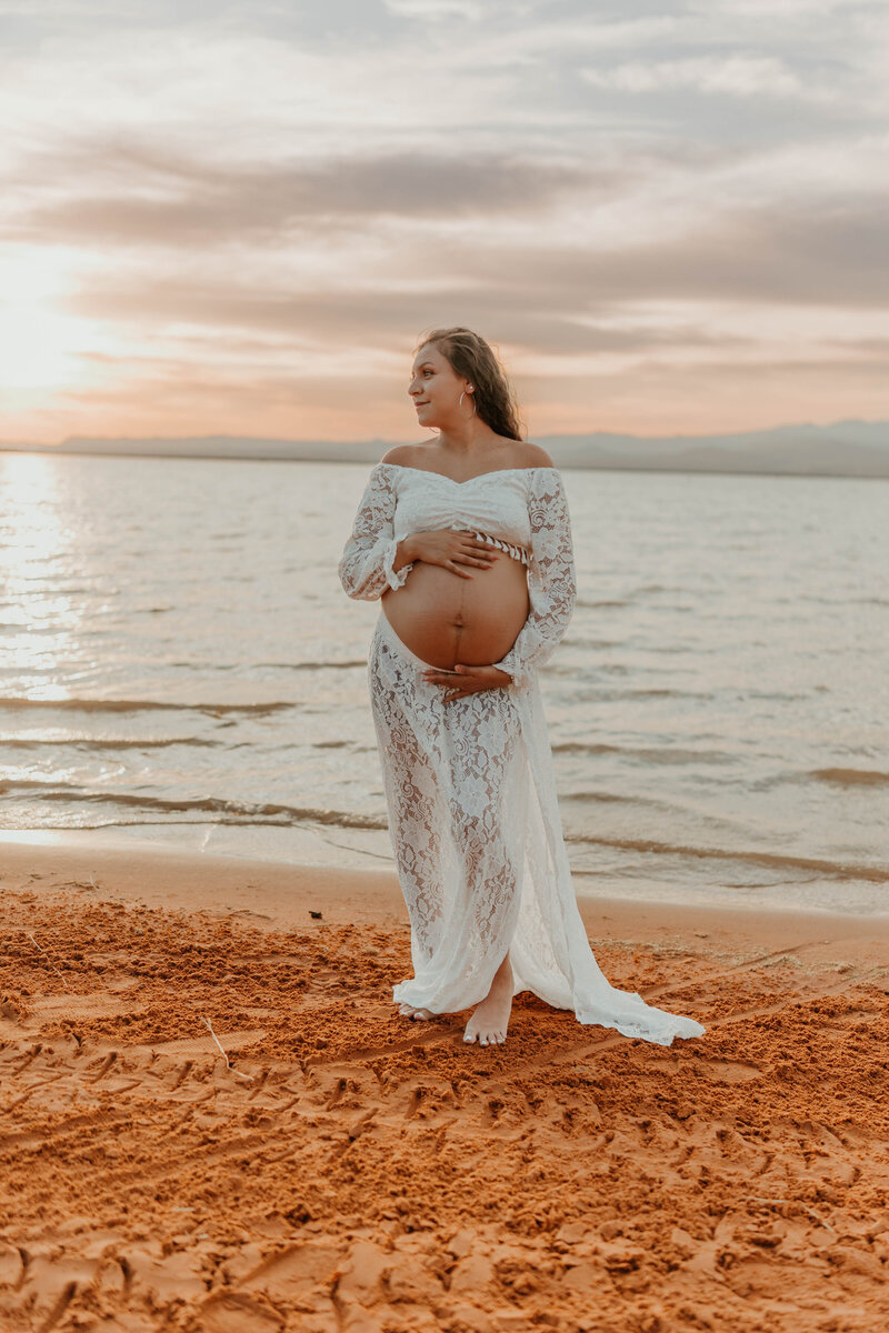  Pregnant woman lounging in home setting, showing the intimacy and grace of maternity photography.