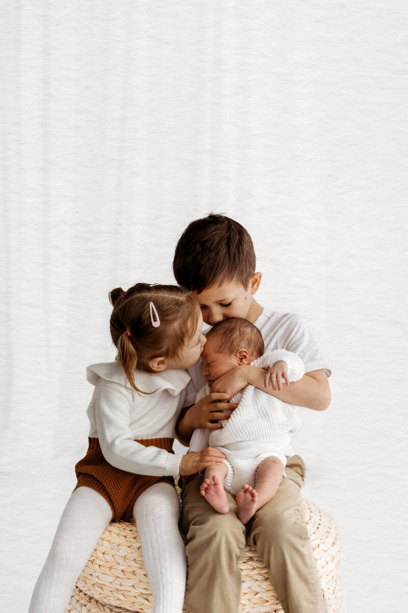 Family session captured by Ashtyn Kohler Photography of three children. Newborn session captured in studio with Ashtyn Kohler Photography. Ashtyn Kohler Photography specializes in newborn and family photography in Olympia, Washington, and surrounding areas. Capture timeless, light, and airy portraits that beautifully preserve the fleeting moments of your baby's early years with a natural, heartfelt approach.