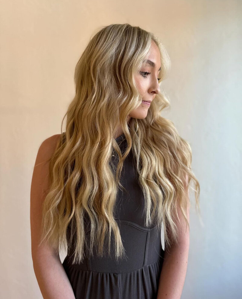 Luxury blonde extensions on client searching for best hair extension salon in Wisconsin