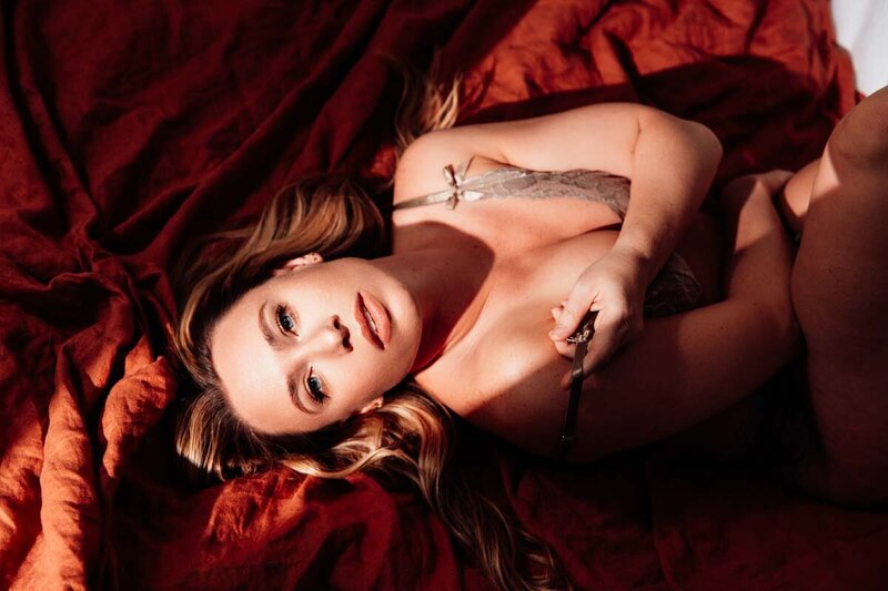 boudoir portrait of blonde woman with dramatic lighting