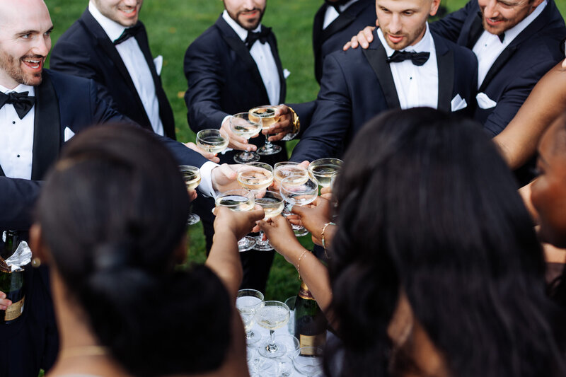 Bridal party having a champagne toast together at Crossed Keys Estate in Andover, NJ .