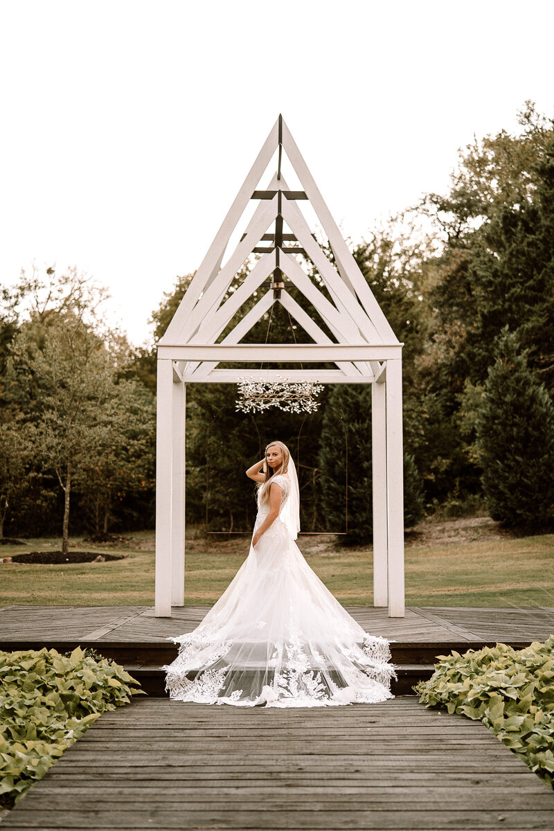 bride posing by chapel