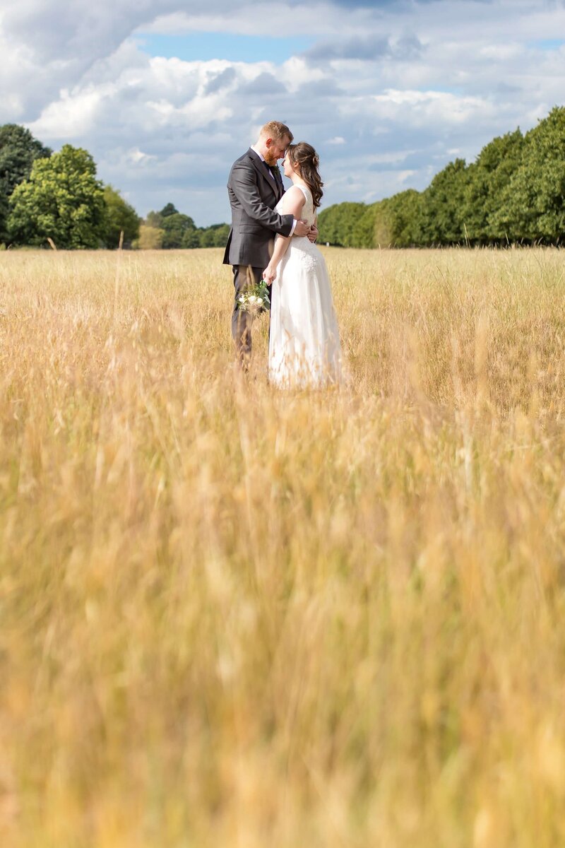 Bride and groom in a field