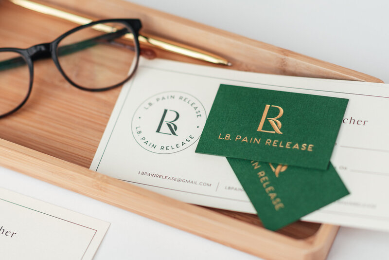 Green and gold business cards with glasses for wellness business brand