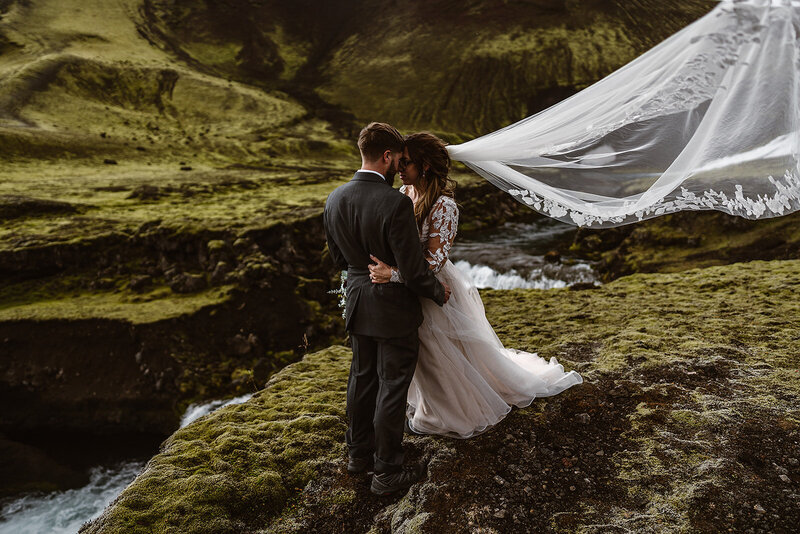 bride and groom on cliffside