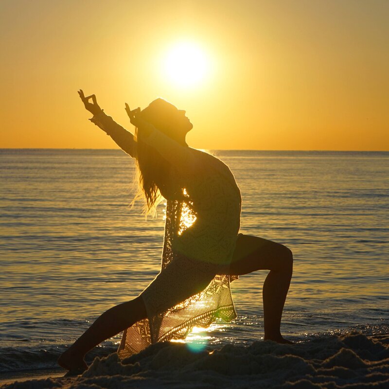 Stephanie in crescent dragon pose on the beach at sunset 
