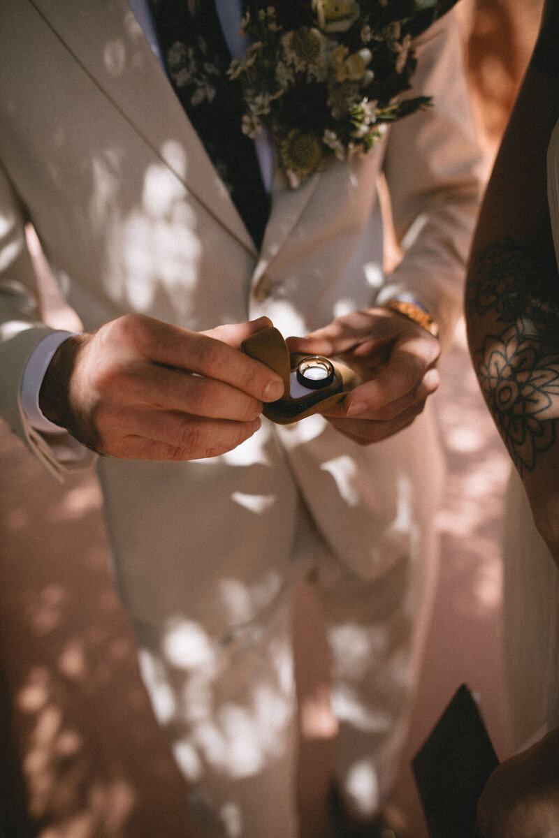 White roses with bride and groom wedding bands