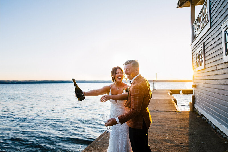 bride popping champagne with groom, syracuse wedding photographer