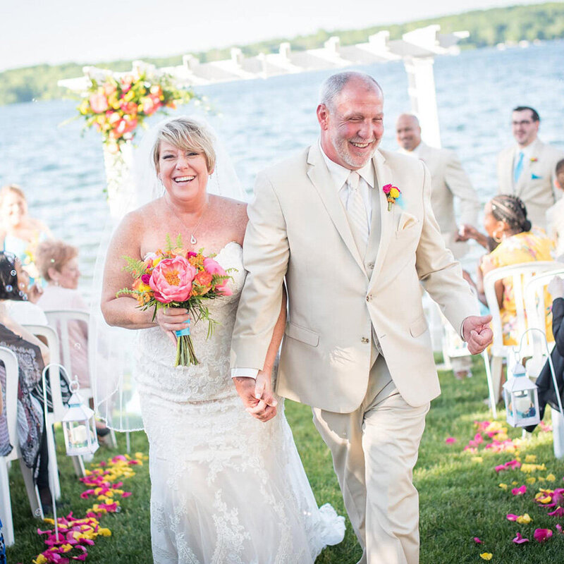 bride and groom walking down the aisle after wedding