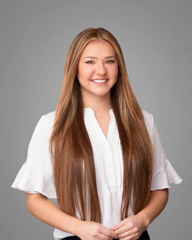 Young insurance agent takes a headshot for her business cards