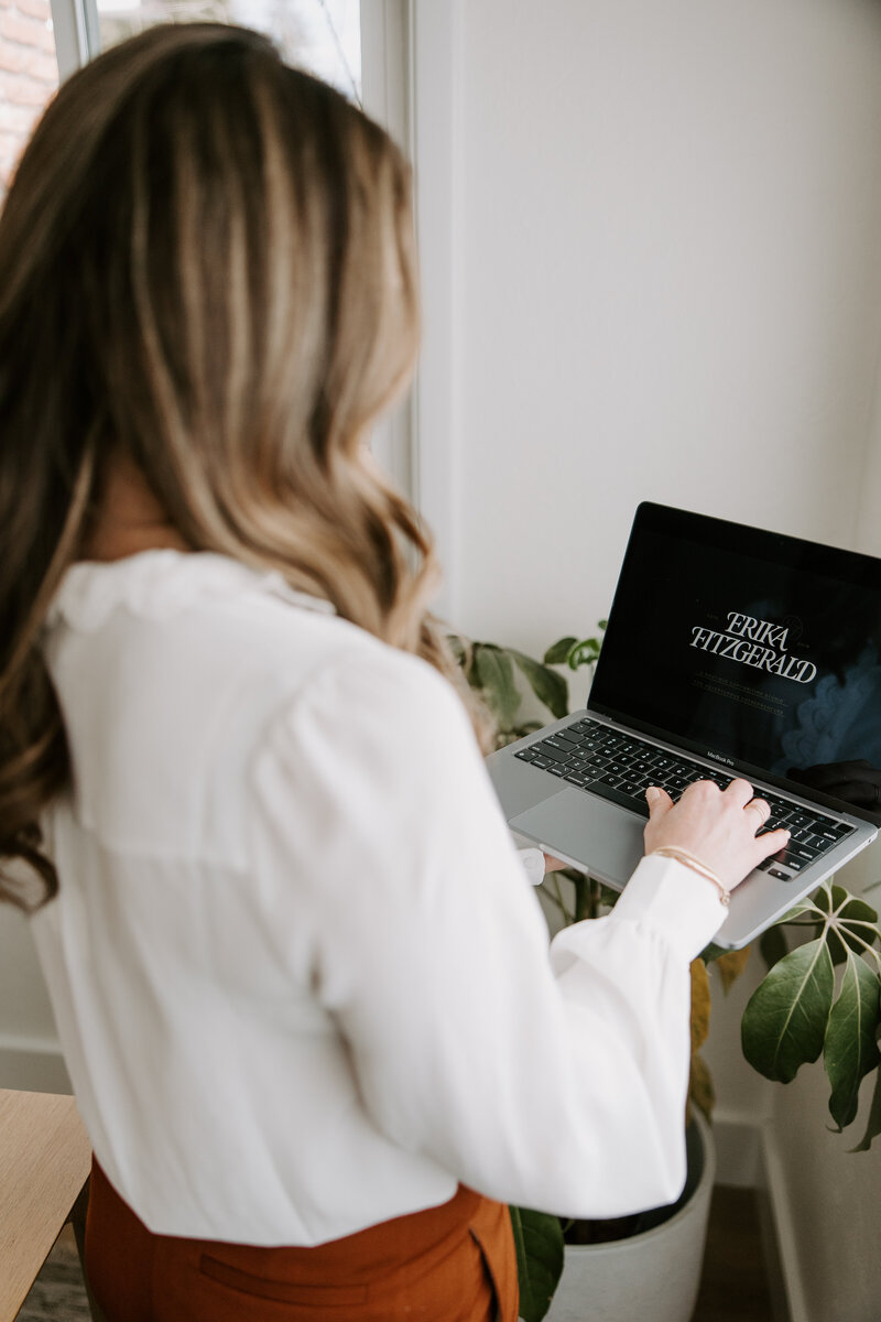 A copywriter for websites holding a laptop