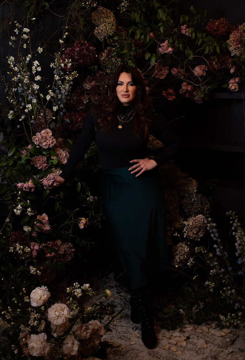 Amanda Lamar - A Morgan Floral Design Owner, image of a woman with a Dutch Masters Inspired floral vignette dark background and antique style florals