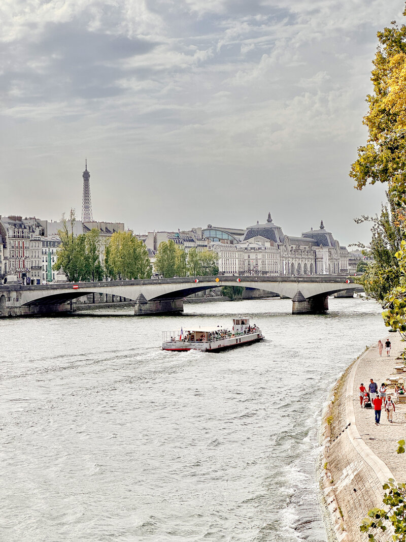 Paris seine river with sidewalk and boat 