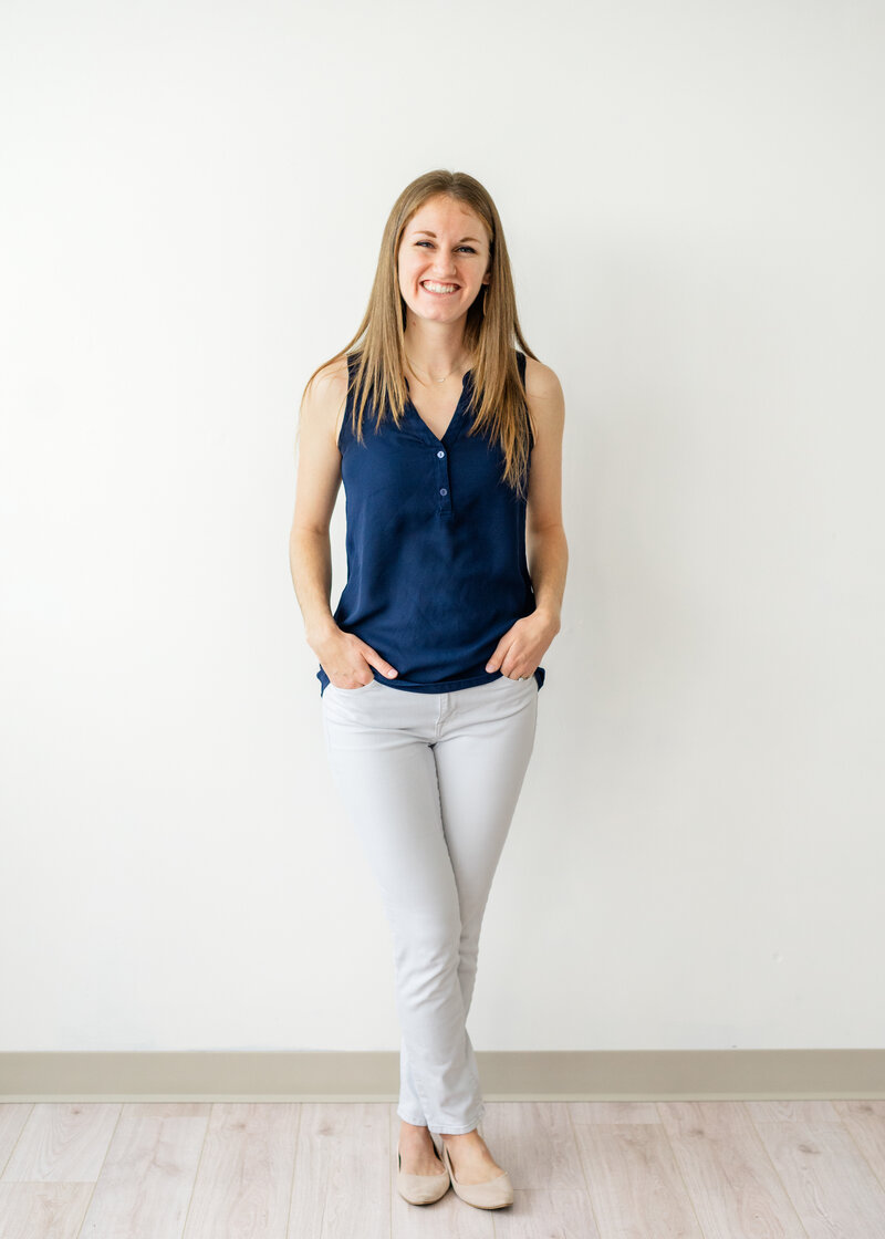 Headshot of Liz standing in a studio