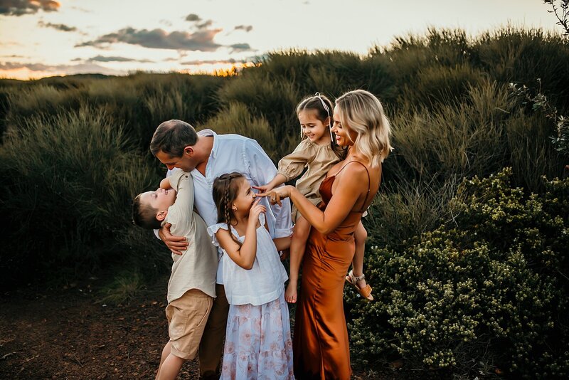 Adorable family with 3 children posing and smiling