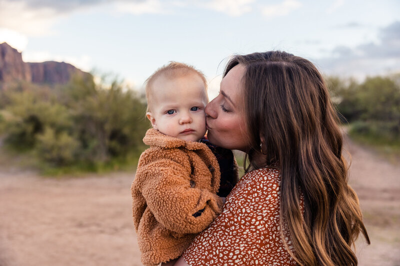mother kissing baby