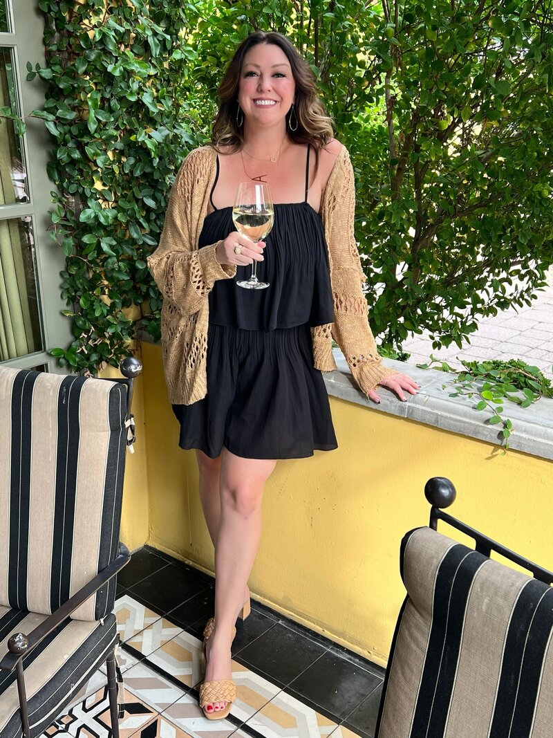Anne smiling with a drink