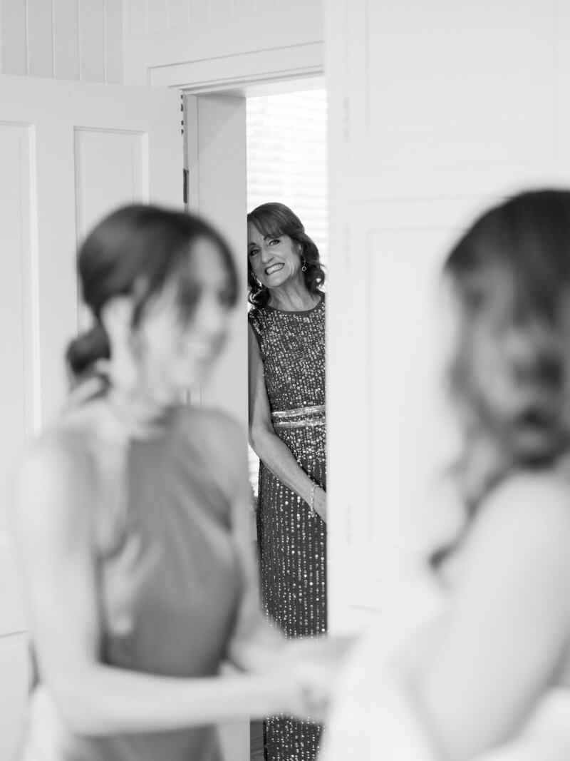 Bride getting ready in a light-filled room at The Allan House with vintage details