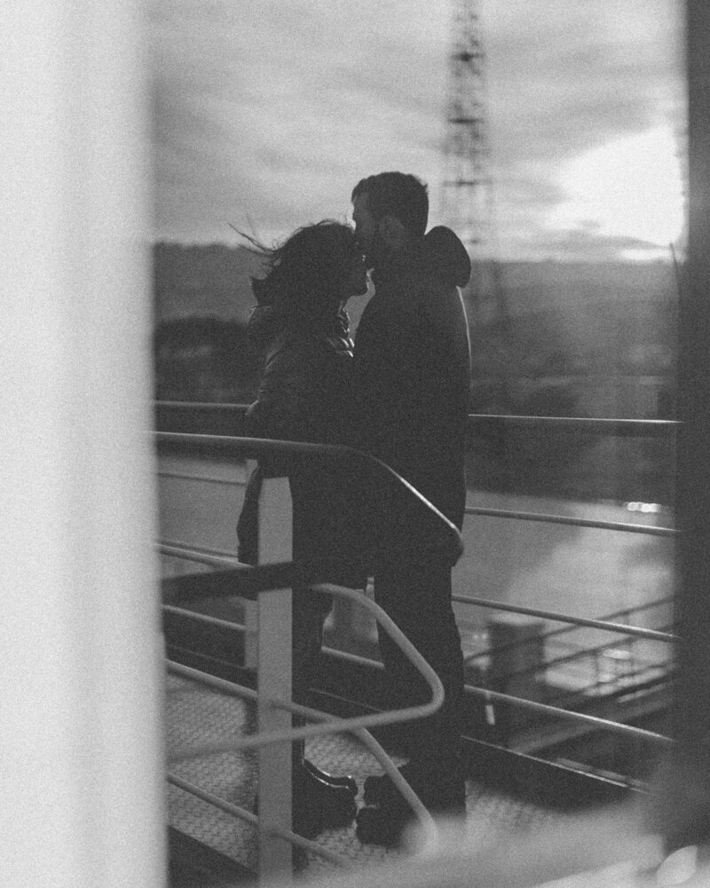 Slightly blurry black & white photo of a man kissing a woman on the forehead. Showing the strength your relationship can get with couples therapy or marriage counseling in Manhattan, NY. Build your connection with support of a Manhattan couples therapist.