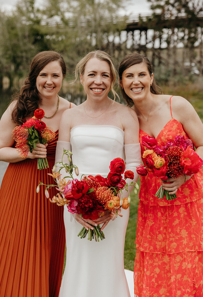 Spring wedding bouquet with protea, lilies, and garden roses
