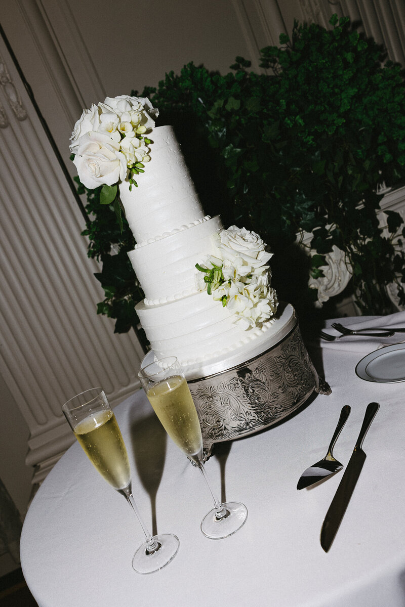 Vermont Wedding Photographer | Sincerely Liz Photography Documentary Wedding, Engagement, Elopement, Maternity and Newborn Photographer in New England | Three-tiered white wedding cake with champagne