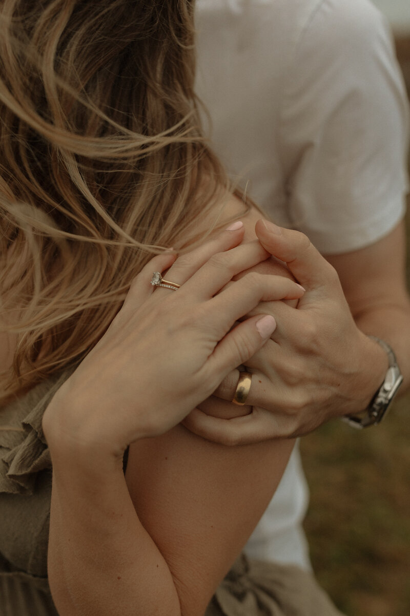 couple holding hands during lifestyle photo session in pei