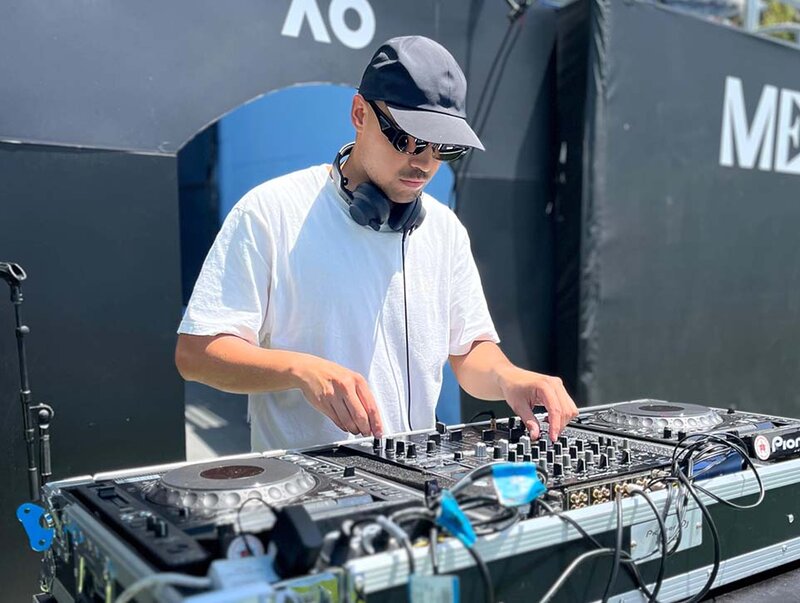 Australian Open DJ performing live with professional DJ equipment during tennis event