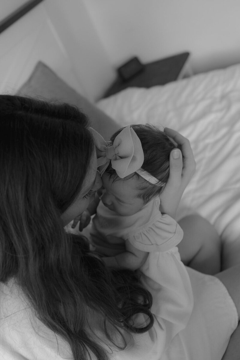 Black and white photo of a mother cradling her newborn baby