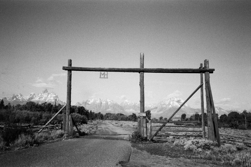Ranch entrance in Jackson Hole, WY with Grand Teton mountains in the background.