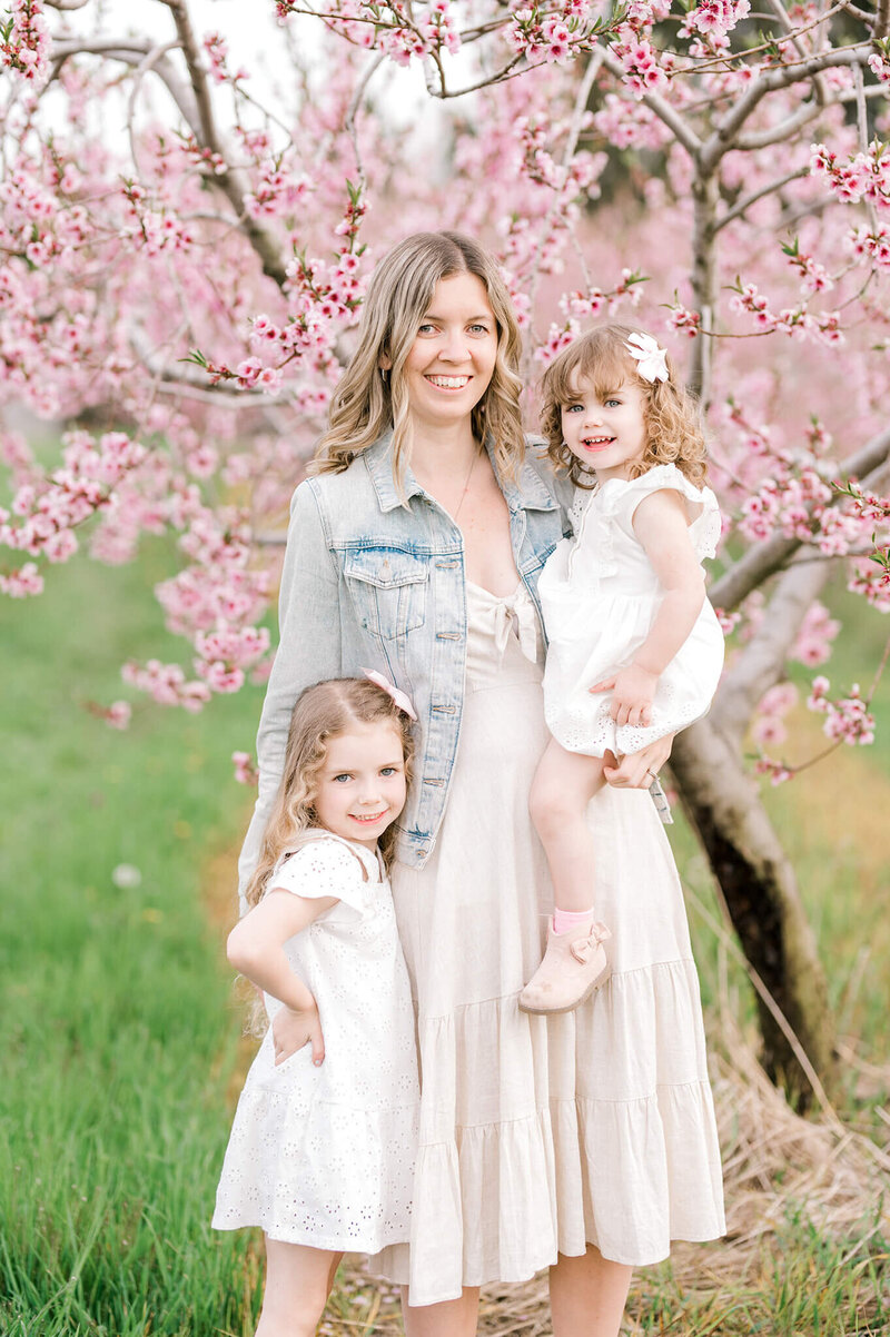 main photographer with her daughters in front of cherry blossoms