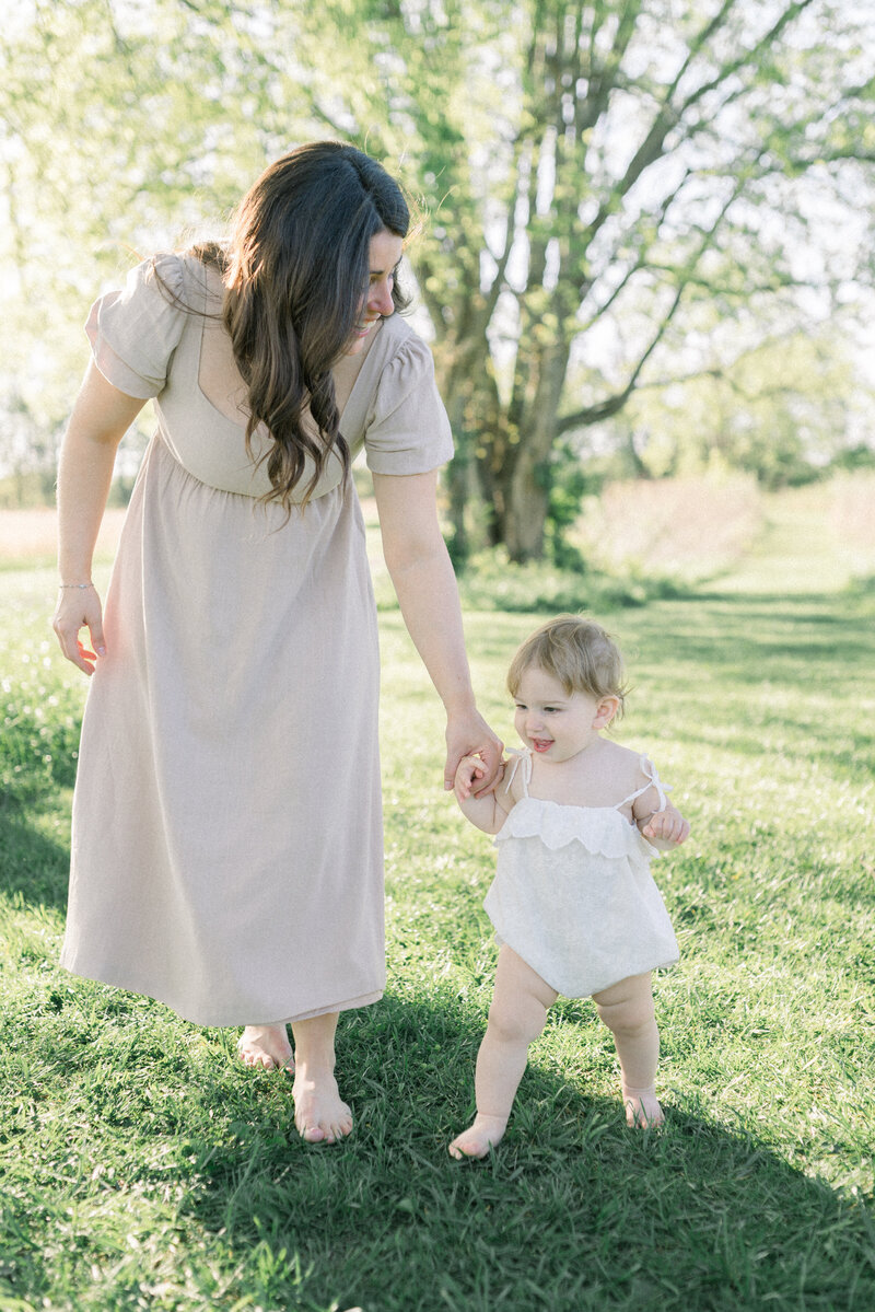 women holding little girls hand while walking knoxville tennessee newborn photographer