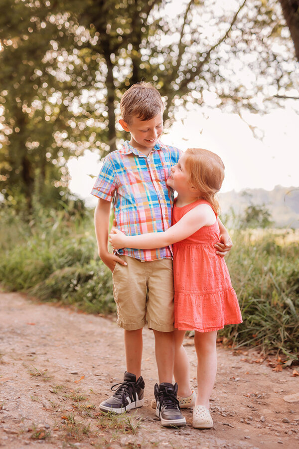 Sisters embrace during Fall Family Photos in Asheville, NC.