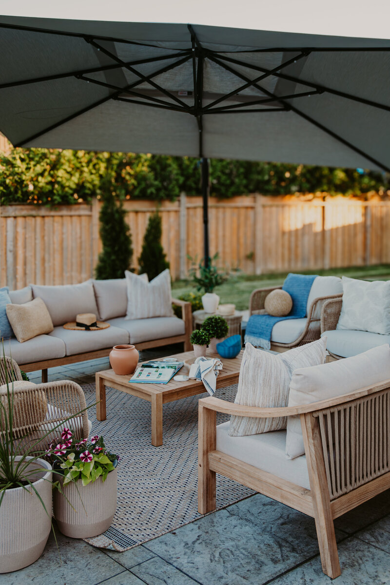 backyard patio with two sofas and accent chairs with coffee table in the center