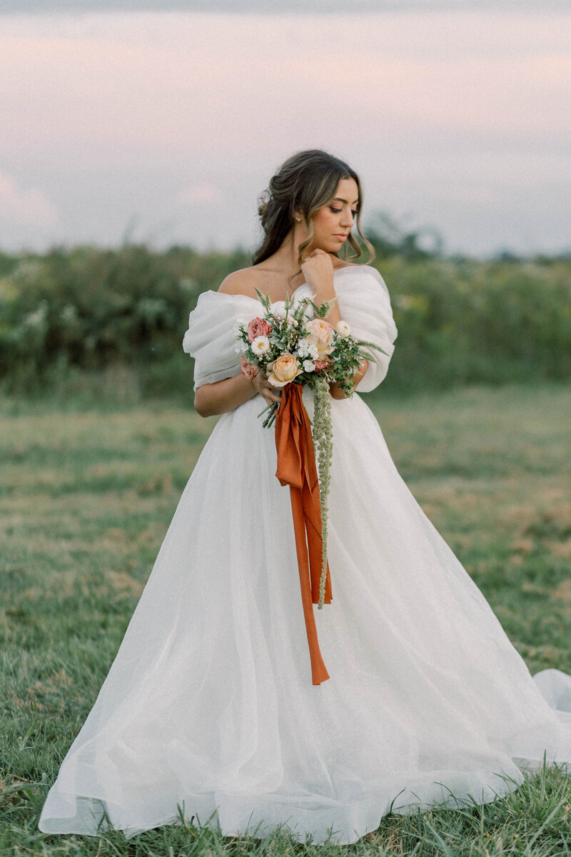 knoxville bridal portrait on film at marblegate farm holding fall inspired bouquet by thistle and lace florals