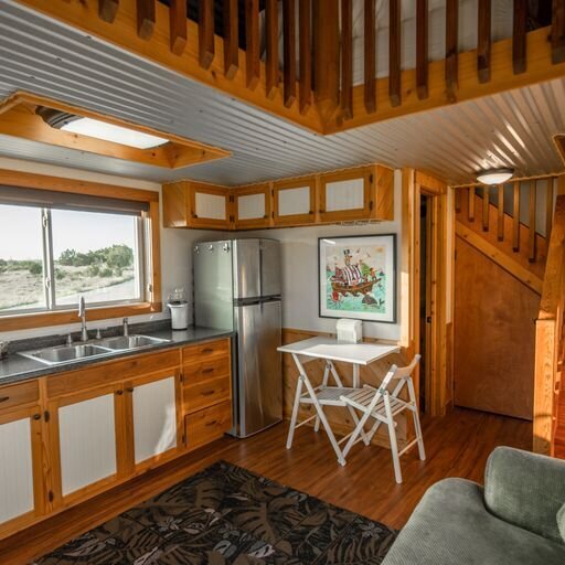 Cabin kitchen with white and wooden cabinets