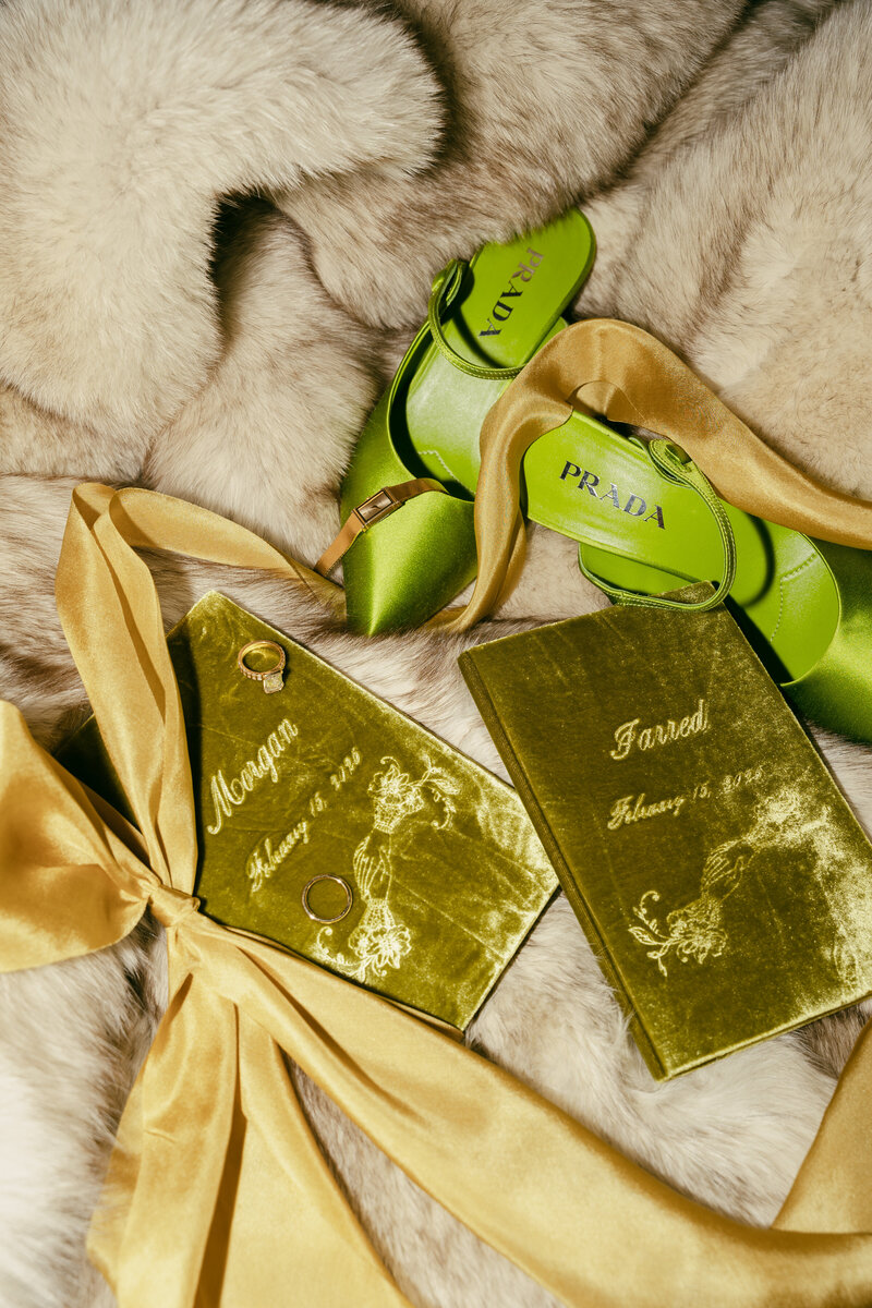 Green velvet vow books with rings and green Prada heels for details.