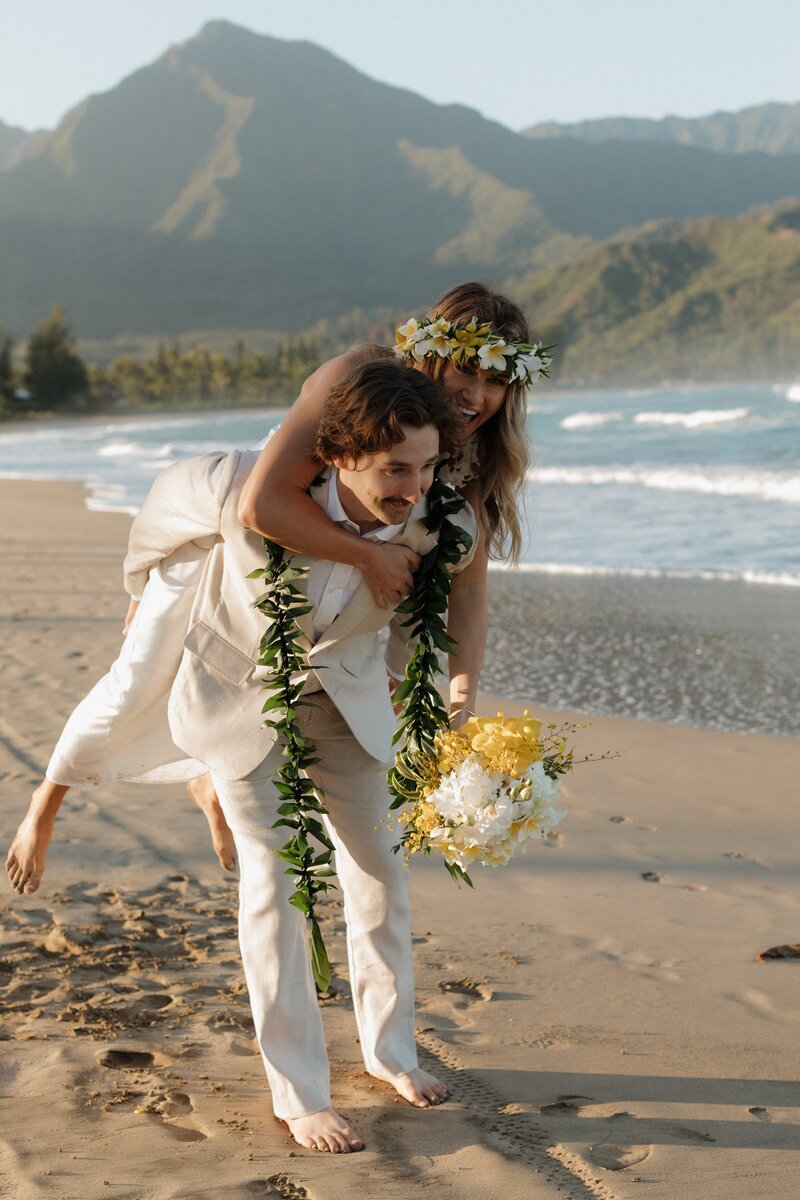 bride and groom on beach at hanalei bay in Kaua'i