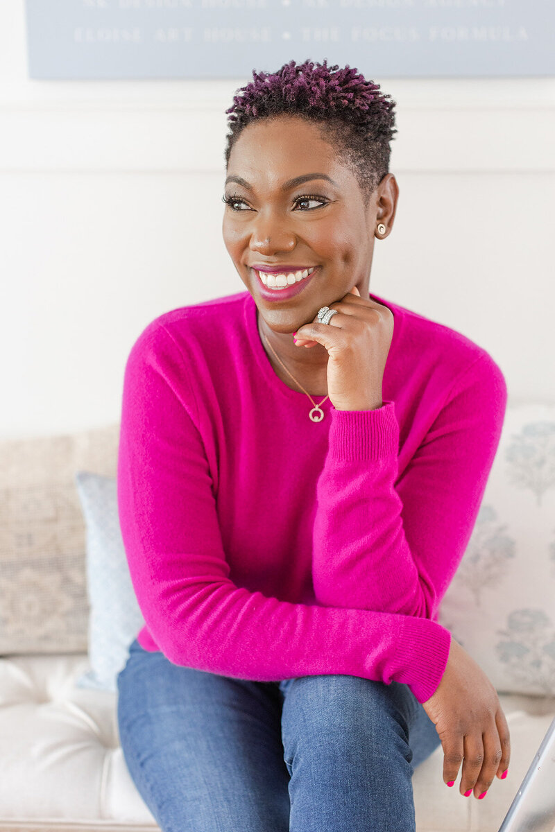 Woman drinking a wine while looking at her laptop
