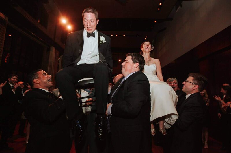 The bride and groom dance the hora while laughing and smiling in Georgetown DC.