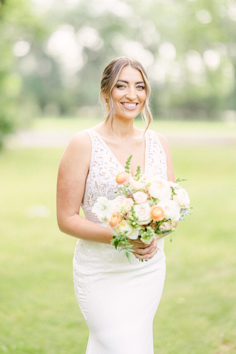 This charming portrait captures the bride smiling radiantly at the Norland Historic Estate in Lethbridge. The estate’s elegant surroundings perfectly frame her joyful expression, creating a timeless and heartwarming image of her special day.