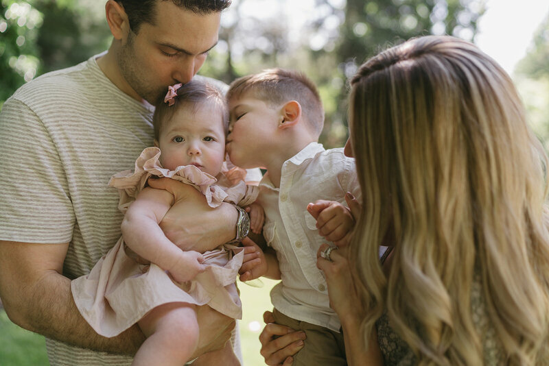 couple holding their kids during family photography session by NYC family photographer Elsie Goodman